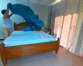 Nudist housekeeper Regina Noir makes the bedding in the bedroom. Naked maid. Naked housewife. 2