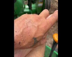 Dirty feet on tractor cutting wood