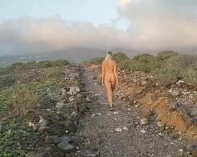 Naked girl in the road to mountains