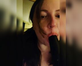 Sucking a big black dildo