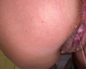 the girl has a hairy pussy with juice and is pissing again at work