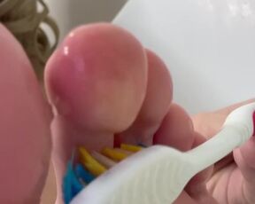 Tickling big feet with a toothbrush